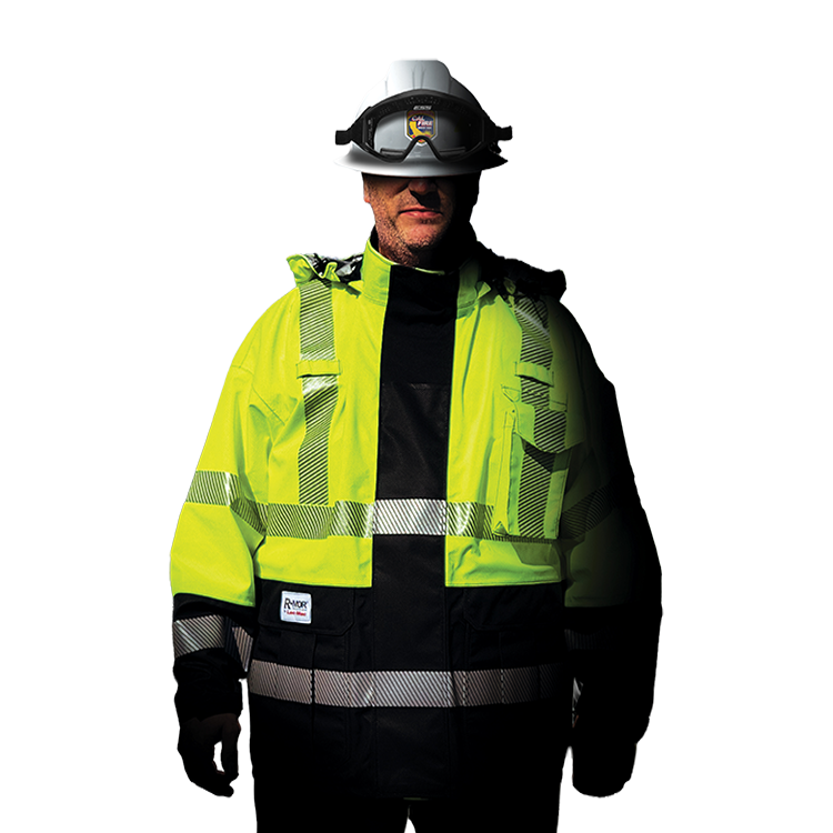 Person wearing a high-visibility jacket and hard hat stands in front of power lines during rain.