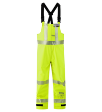 The Lac-Mac Multi-Haz Protective Overall (706ZABH) for flammable liquid chemical hazards is shown in bright yellow with reflective silver stripes and black adjustable suspenders, ANSI 107 compliant, against a white background.
