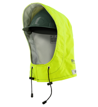A yellow high-visibility helmet cover with a drawstring partially covers a green safety helmet, offering arc flash protection and pairing well with the Lac-Mac Multi-Haz Protective Hood (708ZXC) for flammable liquid chemical hazards.